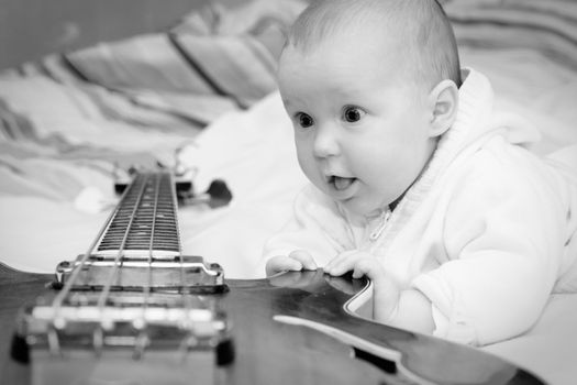 Four month baby girl and the bass guitar, black & white shot
