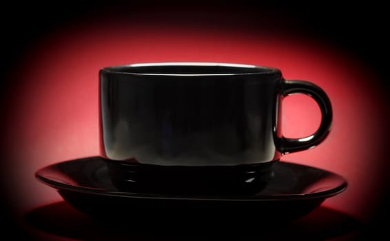 black cup over red background