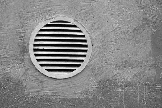 Rusty round lattice on a gray wall