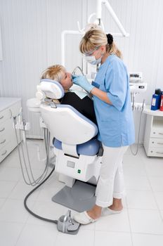 doctor works with patient in the dentist office