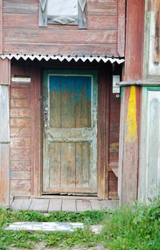 Entrance peeled door on a facade of the ancient house