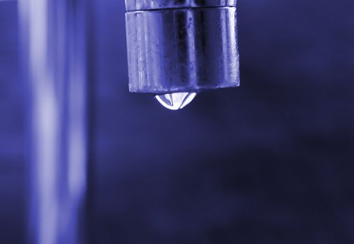 water dripping from a tap focus of the waterdrops
