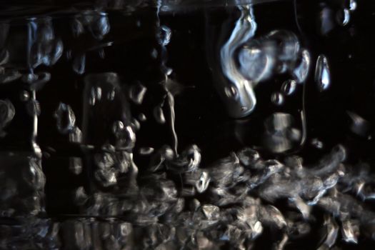 abstract bubbles reflecting light against a dark background