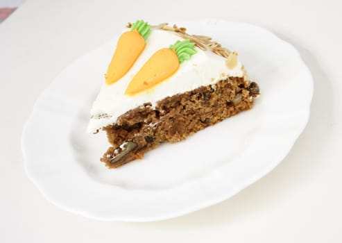 single serving of carrot cake on a white plate