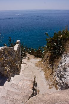 Stoned stairs leading down  to the blue sea. Ponza island, Italy