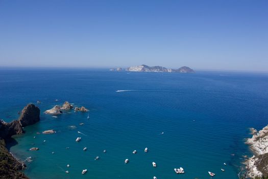 Sea view of blue mediterranean sea, coast and boats. Ponza's coast. Island of Ponza, Italy.