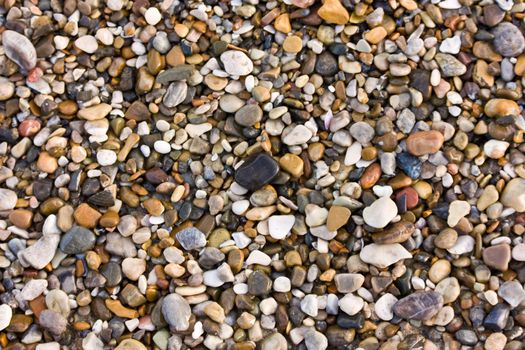 Colorful pebbles on a beach - background texture