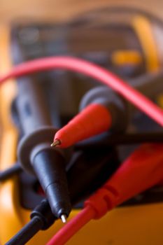 Close up of a digital multimeter with black and red probes