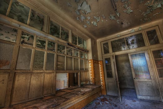 wooden reception desk in an old abandoned building