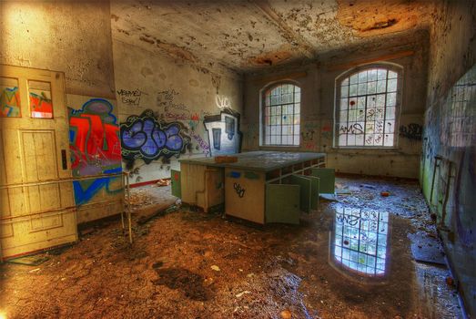 old laboratory with a puddle and graffiti