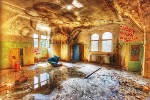 Room in an abandoned building with some furniture