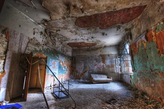 Room in an abandoned building with some furniture