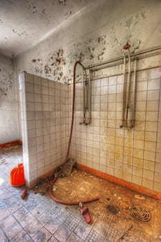 old shower and one shoe in an abandoned building