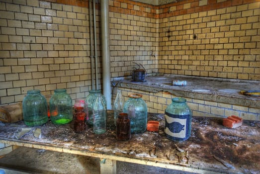 Old bottles with chemical fluids on a cupboard