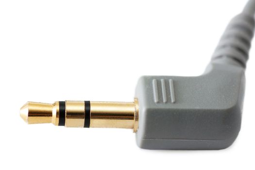 Golden headphone plug isolated on white
