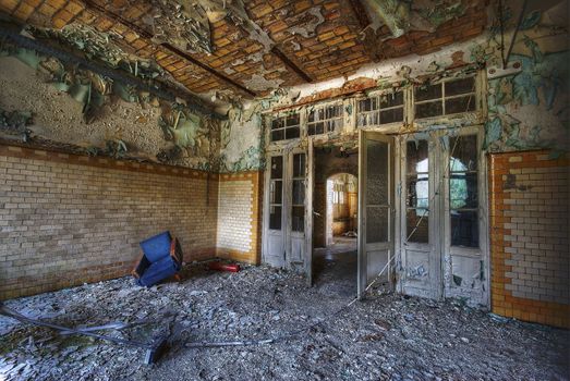 Room in an abandoned building with some furniture