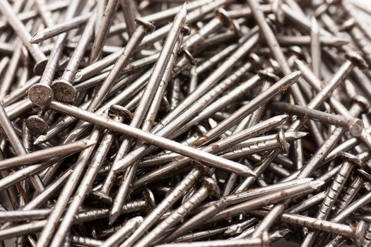 Large pile of steel oiling nails. Macro shot.