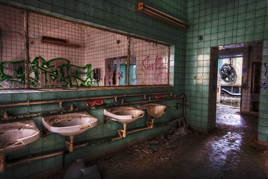 bathroom with sinks and a missing mirror