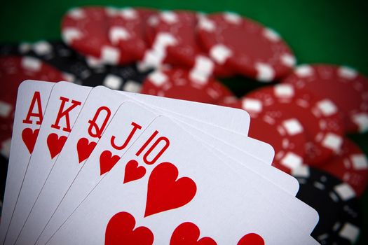 Cards with poker arrangement and poker chips in the background.