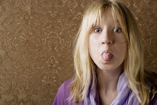 Pretty young girl sticking out her tongue