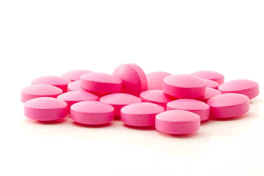 some pink painkiller pills on white background