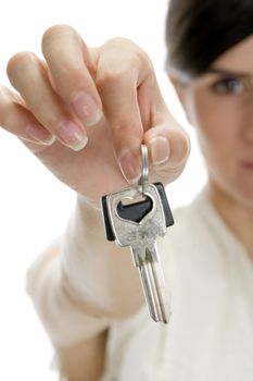 woman showing keys on an isolated white background