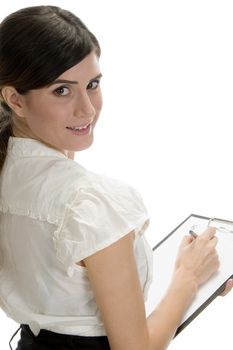 smiling lady with pen and paper in writing pad on an isolated background