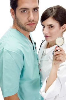 nurse standing with patient showing stethoscope with white background