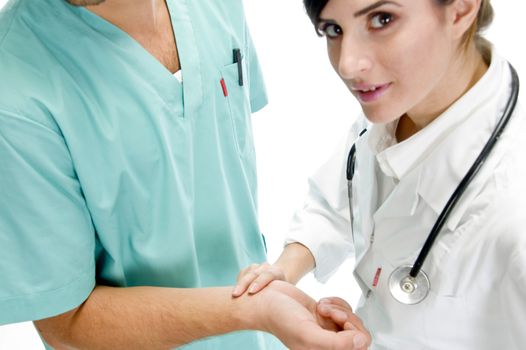 young nurse checking pulse of patient with white background