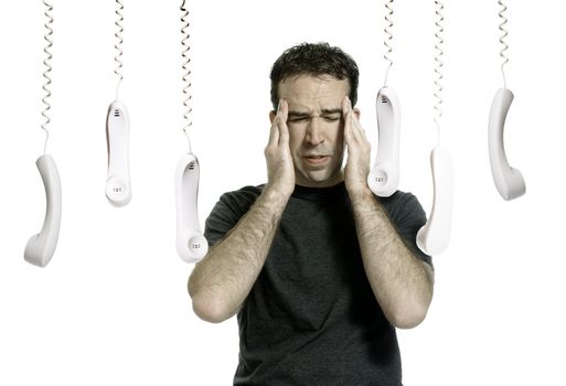 A young man stressed out from all the phone calls, isolated against a white background.