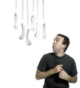 A young man worried about an imminent phone call he is about to receive, isolated against a white background.