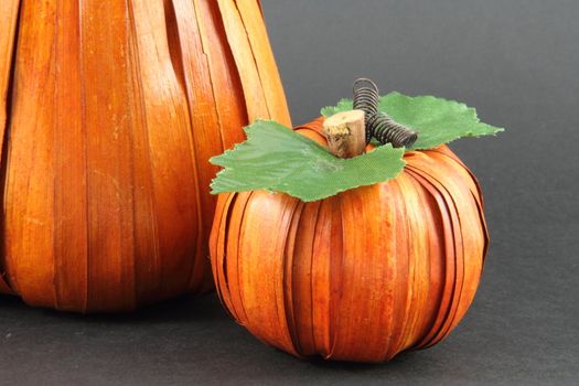 An artist interpretation of two pumpkins on a grey background.