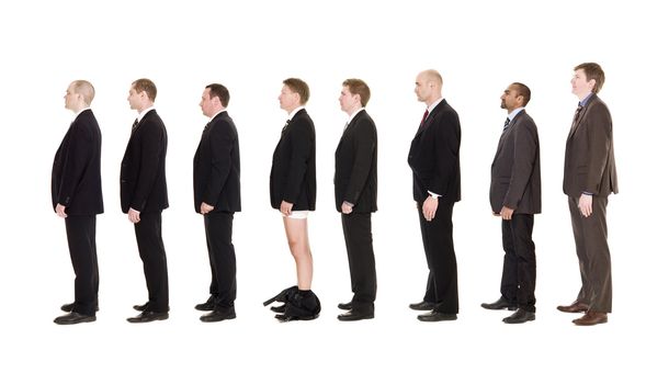 Man with his pants down standing in line together with other men