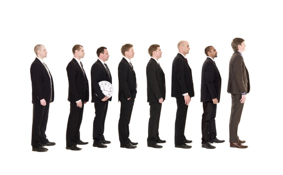 Man holding a clock standing in line with other men