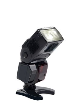 Flashgun mounted on a plate, onto white background 