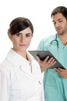 busy doctor looking writing pad and nurse looking you on an isolated background