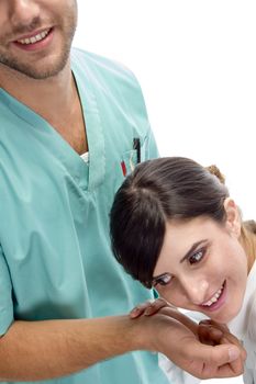 smiling nurse checking pulse of patient on an isolated white background