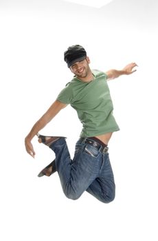 young man leaps in air on an isolated white background