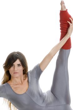 woman stretching her leg against white background