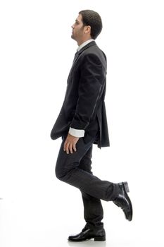 side pose of young businessman against white background