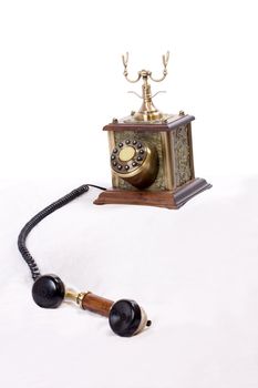 Vintage phone with picked up receiver on white background