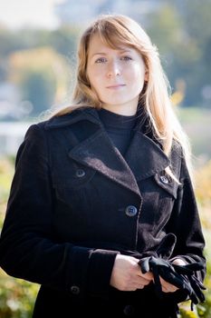 Portrait of beautiful blond woman in a park