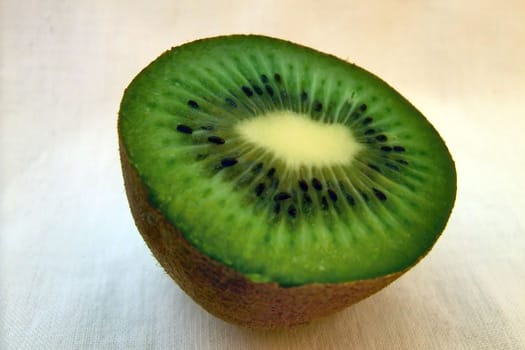 Close picture of kiwi fruit cut on two pices and shown inside