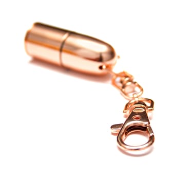 Bright copper charm for keys. Isolation on the white. Shallow DOF