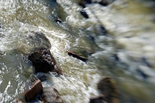 River water rushing over rapids. Blur effect is done in-camera using Lensbaby.
