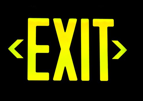 Yellow exit neon sign on black background