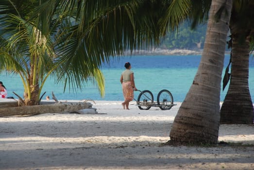 Woman working on a tropical beach