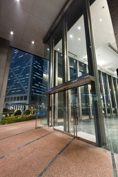 entrance of a modern building at night in hong kong