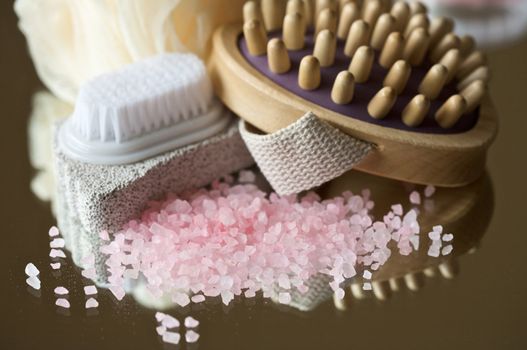 Various massage and exfoliating tools with bath salt