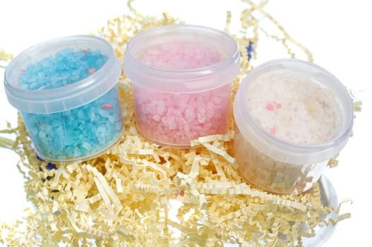 Three different colored tubs with bath salt in various flavours